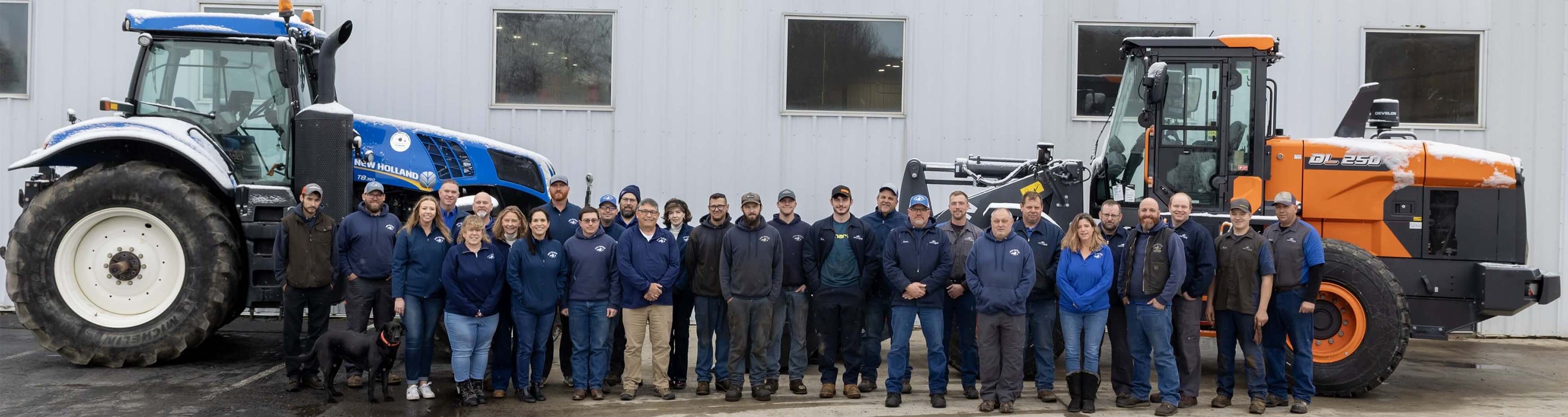 Group photo of staff standing in front of equipment